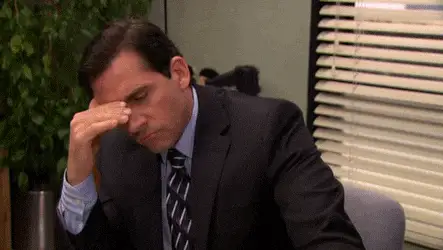 GIF: genervter Mann im Büro reibt sich die Augen